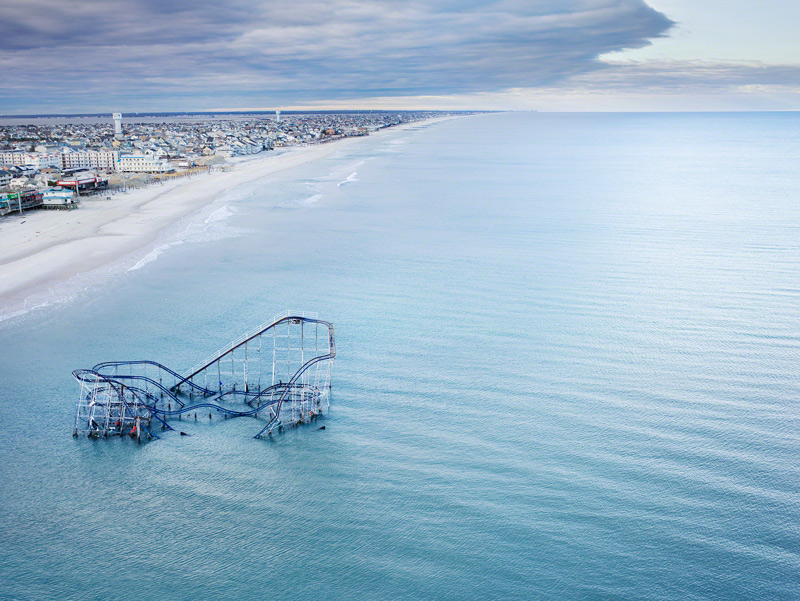 The roller coaster from the boardwalk in Seaside Heights, New Jersey partially submerged in the ocean after Hurricane Sandy. © Stephen Wilkes courtesy of Peter Fetterman Gallery